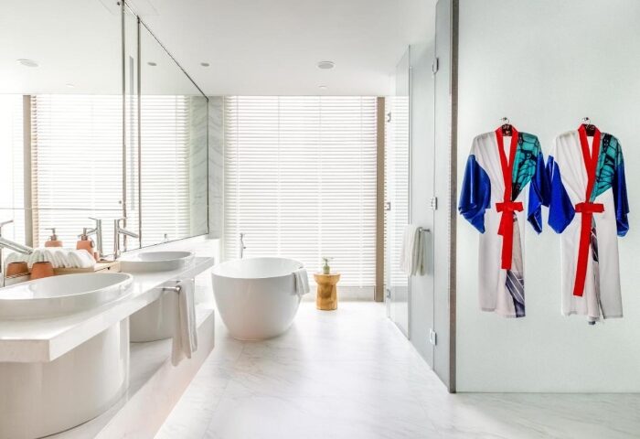 Kimpton Maa-Lai Bangkok bathroom, Mr and Mr honeymoon. Two robes hang in the luxury hotel, a top gay honeymoon destination in Bangkok.
