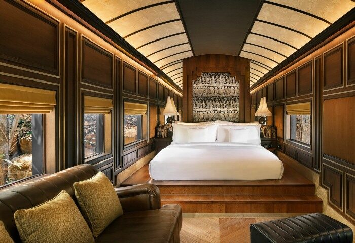 InterContinental Khao Yai Resort suite. Top gay honeymoon hotels. Luxury train-themed room with bed, sofa, and view. Khao Yai, Thailand travel.