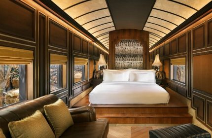 InterContinental Khao Yai Resort suite. Top gay honeymoon hotels. Luxury train-themed room with bed, sofa, and view. Khao Yai, Thailand travel.