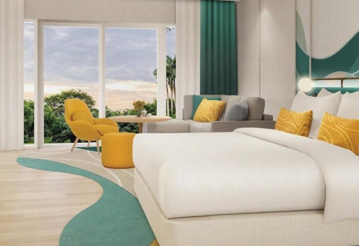 M Social Hotel Phuket room. Modern gay honeymoon hotel room with yellow accents, a sofa, and a view. Top choice for gay couples in Phuket.