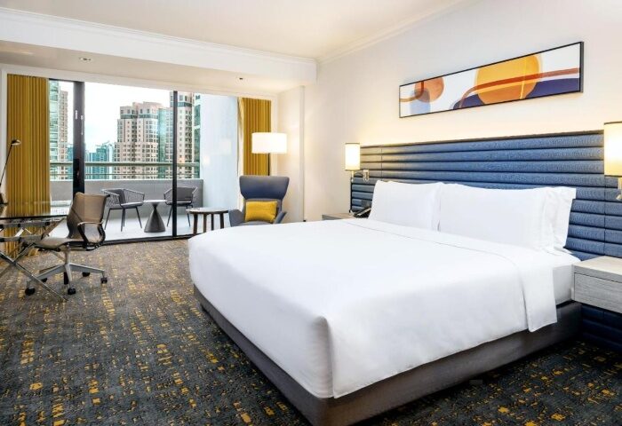 voco Orchard Singapore hotel room. Balcony with city views. Gay honeymoon destination in Singapore. IHG Hotel.