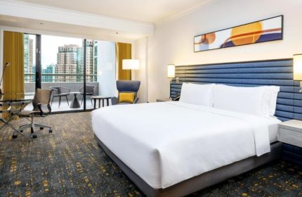 voco Orchard Singapore hotel room. Balcony with city views. Gay honeymoon destination in Singapore. IHG Hotel.