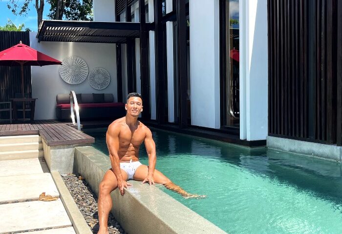 Gay honeymoon at W Koh Samui pool villa. Man in swimwear sits by the pool. Top gay hotels for honeymoons and travel advice.