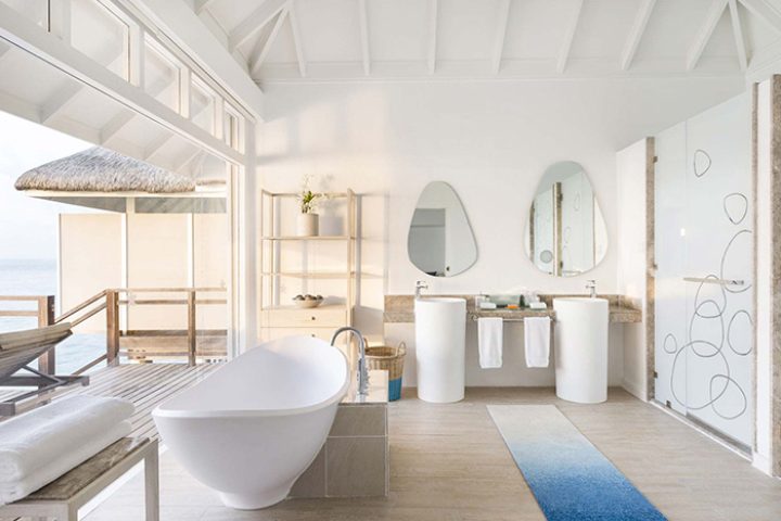 LUX* South Ari Atoll Maldives gay honeymoon. Pool villa bathroom with tub, double sinks, and ocean view. Top Maldives honeymoon destination.