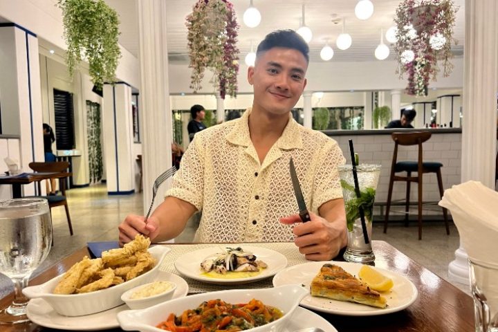 Gay man enjoying fine dining at Double-Six Luxury Hotel Seminyak, Bali. Top gay hotel in Bali with delicious food and a great atmosphere.
