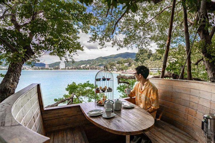 Amari Phuket gay hotel choice: Man enjoys tea with a sea view. Top Thailand destination for gay men, offering luxury and relaxation.