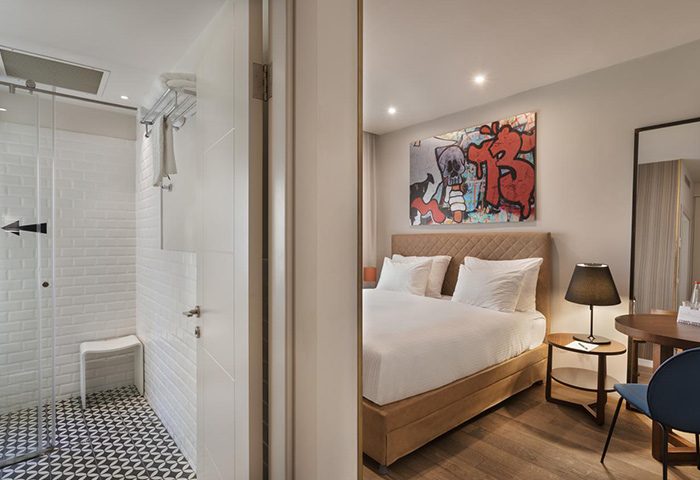 Shenkin Hotel room for 3 gay adults in Tel Aviv: modern design with bathroom and bedroom. Top gay hotel room with graffiti art.