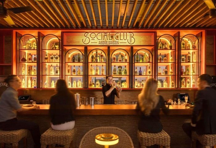 Hotel Des Arts Saigon MGallery Collection bar. Bartender mixing drinks at a top gay hotel near gay bars in Ho Chi Minh City.