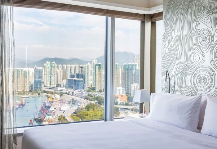 W Hong Kong hotel room view of Victoria Harbour. A top gay hotel with city views, skyscrapers, and a modern design.