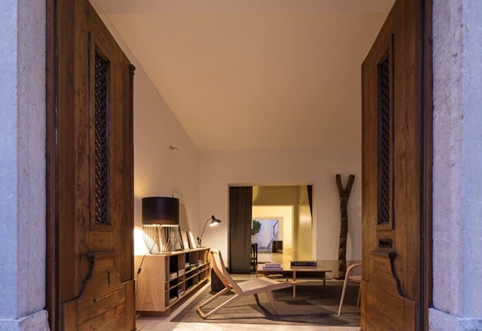 The Late Birds Lisbon, gay urban resort. Interior view through open wooden doors. Stylish design, Lisbon gay hotel.