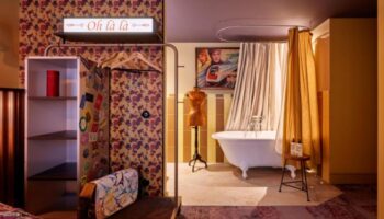 25hours Hotel Terminus Nord bathroom. One of the top gay hotels in Paris on TikTok. Features vintage decor, bathtub, and Oh là là sign.