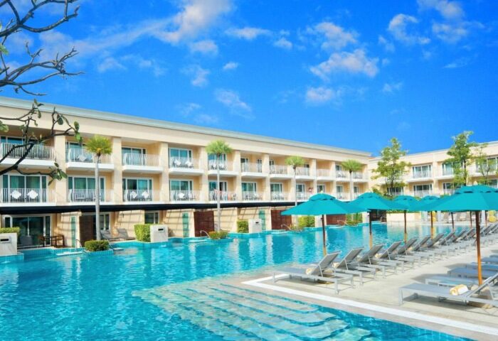 M Social Hotel Phuket pool view. Top gay hotels in Patong party beach. Swimming pool with sun loungers and umbrellas. Phuket travel.