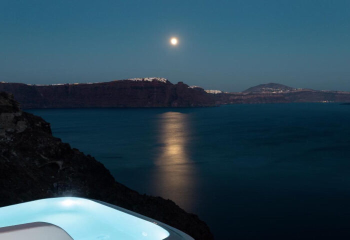 Santorini gay honeymoon: Moonlit caldera view from Armenaki hotel's hot tub. Perfect for gay couples seeking a romantic getaway in Greece.