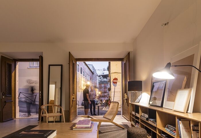 The Late Birds Lisbon gay hotel interior. View through open doors to a Lisbon street scene with two men. Top gay hotels list in Lisbon.