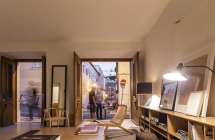 The Late Birds Lisbon gay hotel interior. View through open doors to a Lisbon street scene with two men. Top gay hotels list in Lisbon.
