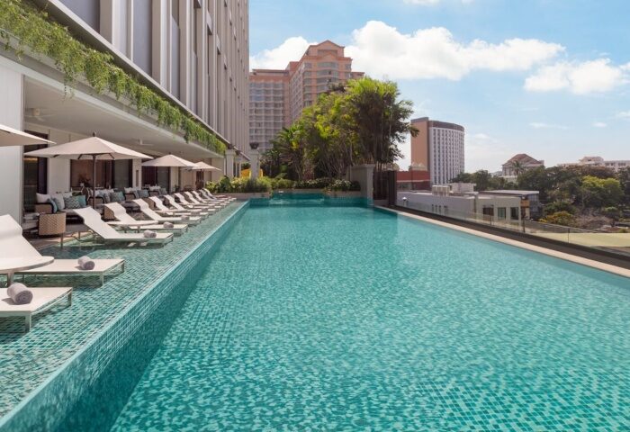 Chiang Mai Marriott Hotel rooftop pool. Luxury gay hotel with sun loungers, parasols, and city views. Top choice for gay travelers in Thailand.