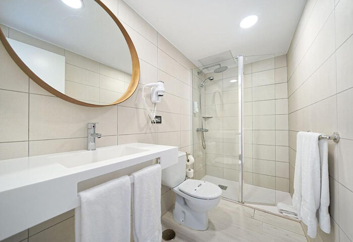 Atlantic Sun Beach gay men only hotel bathroom. Sink, mirror, shower, and toilet in Playa del Ingles adults-only hotel near gay nightlife.