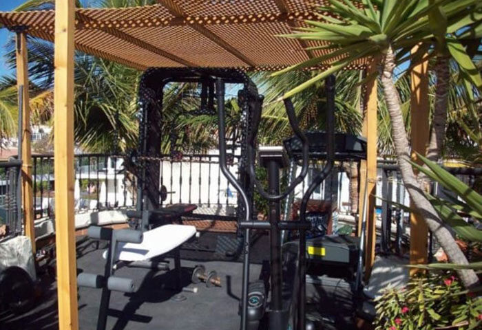 Pasion Tropical Gay Resort gym. Outdoor gym at Playa del Ingles gay men's hotel. Top gay men-only hotel with fitness equipment.