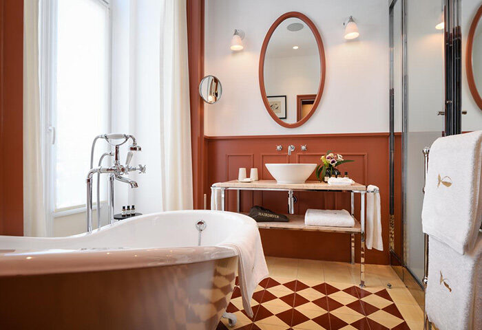 Bairro Alto Hotel, Lisbon gay hotel bathroom. Honeymoon suite near Trombeta Bath gay sauna. Luxury design with tub, sink, and diamond floor.