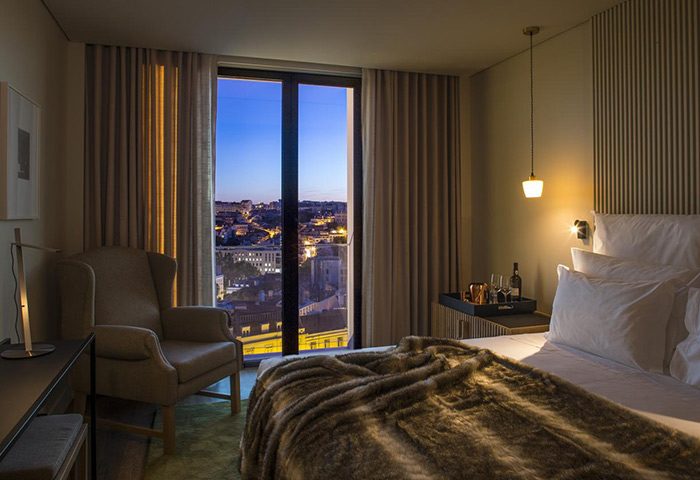 Memmo Principe Real Design Hotel room in Lisbon. City center view from honeymoon suite. Luxury gay travel destination.