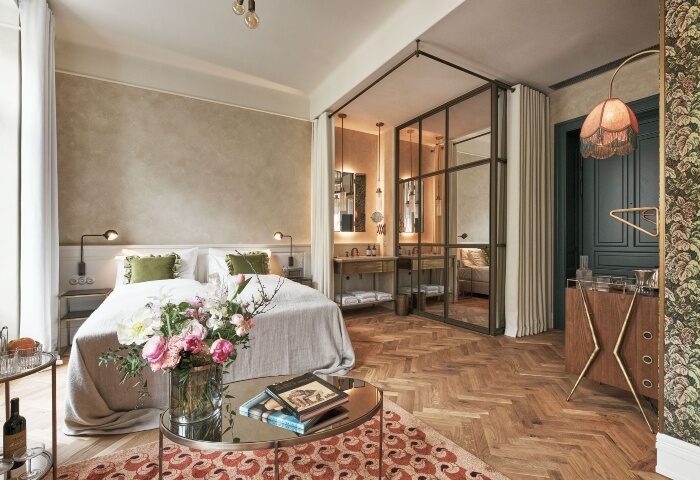 Hotel Motto, Vienna: Honeymoon suite for gay couples. Stylish bedroom with glass-enclosed bathroom, parquet floor, and vintage decor.
