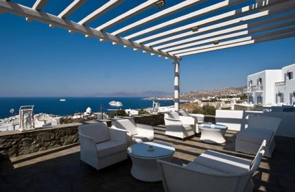 Hermes Mykonos Hotel's Instagramable rooftop terrace with sea view. Gay-friendly hotel in Mykonos gayborhood. White decor, perfect for gay travel.