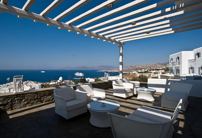 Hermes Mykonos Hotel's Instagramable rooftop terrace with sea view. Gay-friendly hotel in Mykonos gayborhood. White decor, perfect for gay travel.