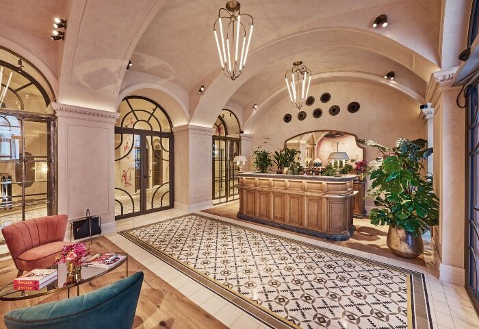 Hotel MOTTO, top Instagrammable hotel in Vienna City Center. Lobby view with arched ceilings, patterned floors, and stylish reception desk.