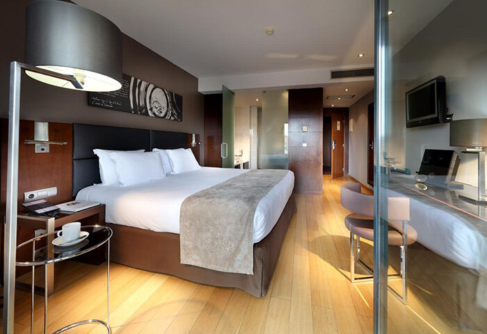 Eurostars Hotel das Letras room. Top luxury gay hotel in Lisbon gayborhood. Modern design, bed, desk, and glass bathroom.