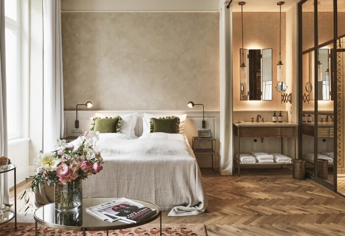 Motto Hotel, Vienna. Luxury room interior near gay bars. King bed, ensuite bathroom, herringbone floor. Top gay-friendly hotel for gay men travel.