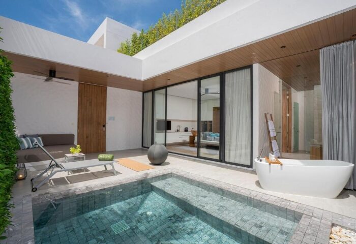 Melia Phuket Mai Khao top luxury gay private pool villa. Beachfront resort view with outdoor tub, lounge chair, and modern design.