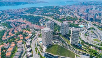 Raffles Istanbul Hotel: Top luxury gay wellness hotel. Aerial view of the hotel, river, and city. Gay travel destination on the river.