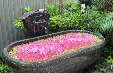 Shinta Mani Angkor Bensley Collection Pool Villas bathtub filled with pink flower petals. Top luxury gay wellness hotel near Angkor Temple.