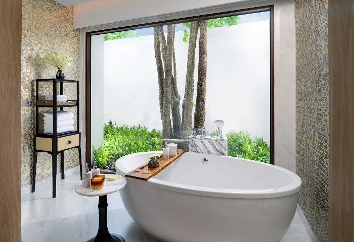 Luxury wellness at InterContinental Phuket Resort, an IHG Hotel. Modern bathroom with tub, garden view. Top gay hotel for relaxing vacations.