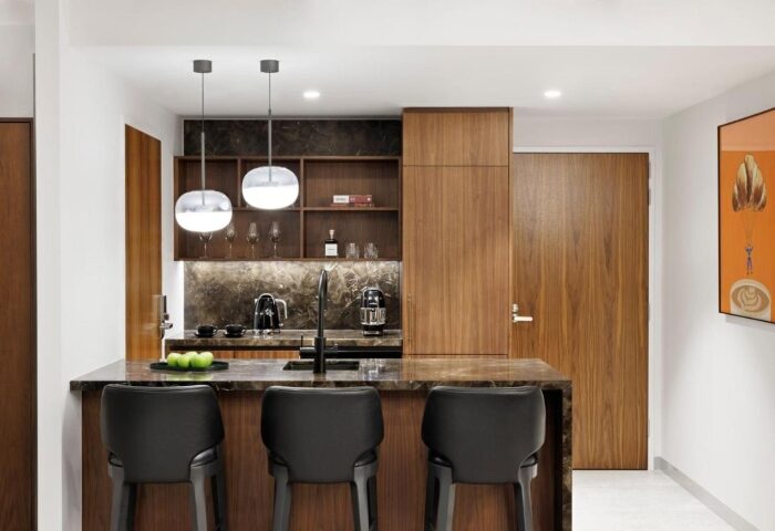Le Meridien Melbourne top luxury suite kitchen. Collingwood gay hotel with bar stools, marble countertop, and modern lighting.