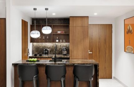 Le Meridien Melbourne top luxury suite kitchen. Collingwood gay hotel with bar stools, marble countertop, and modern lighting.