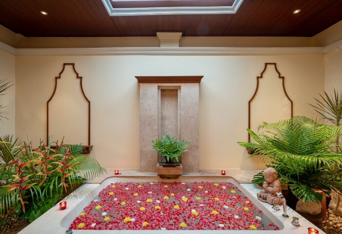 InterContinental Pattaya Resort wellness suite. Top luxury gay beachfront hotel bathtub filled with flowers. Relaxing spa day.
