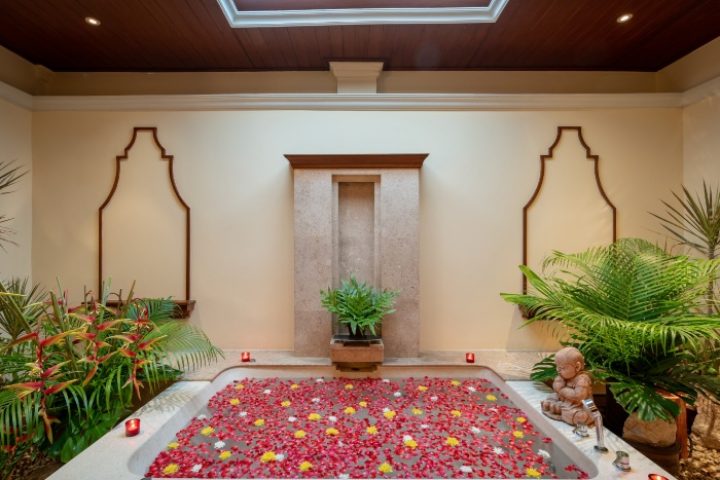 InterContinental Pattaya Resort wellness suite. Top luxury gay beachfront hotel bathtub filled with flowers. Relaxing spa day.