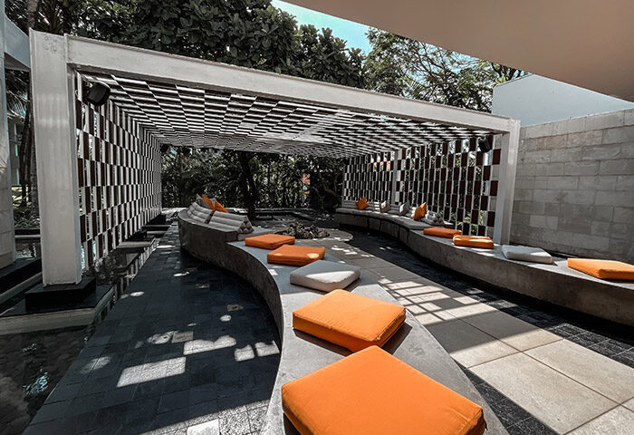 W Bali Seminyak modern beachfront gay hotel lounge area with orange cushions. Stylish design at Bali's top gay-friendly resort.