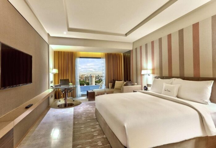 DoubleTree by Hilton Hotel Sukhumvit Bangkok room. Modern gay-friendly hotel with a bed, desk, and city view. Top hotel for gay travel.