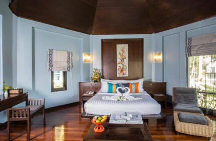 Peace Laguna Resort's top private pool villa. Gay hotel in Ao Nang, Krabi. Bedroom with king bed, swan towels, and wood floors.