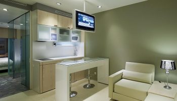 Ako Suites Hotel serviced apartment interior. Gay hotel in Barcelona's Eixample gayborhood. Modern design with kitchen, bar, and living area.