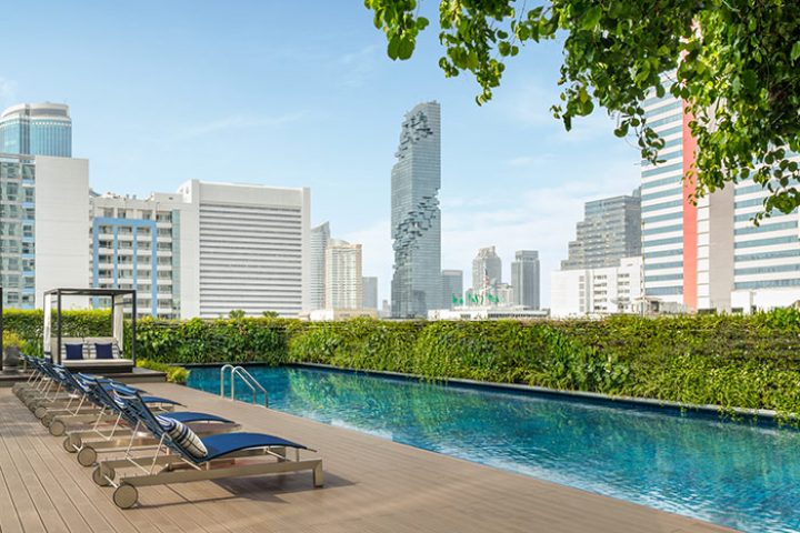 Le Méridien Bangkok rooftop pool. Gay hotel in Bangkok with city views, sun loungers, and modern design. Top TikTok spot.
