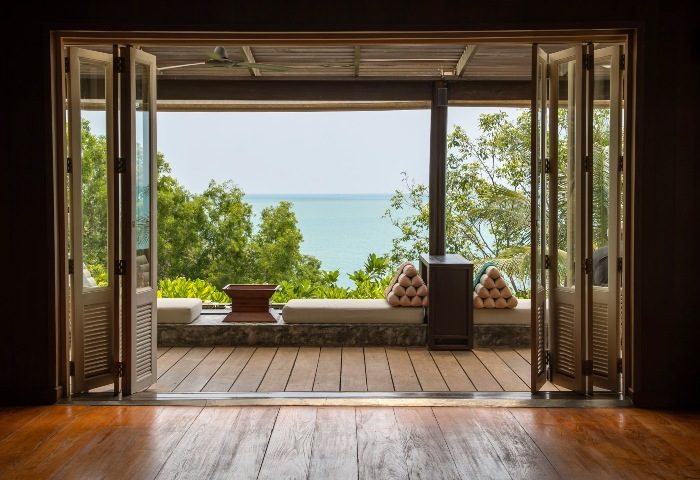 Garrya Tongsai Bay Samui beachfront view from suite. Top transgender gay hotel with ocean view, wooden deck, and open doors.