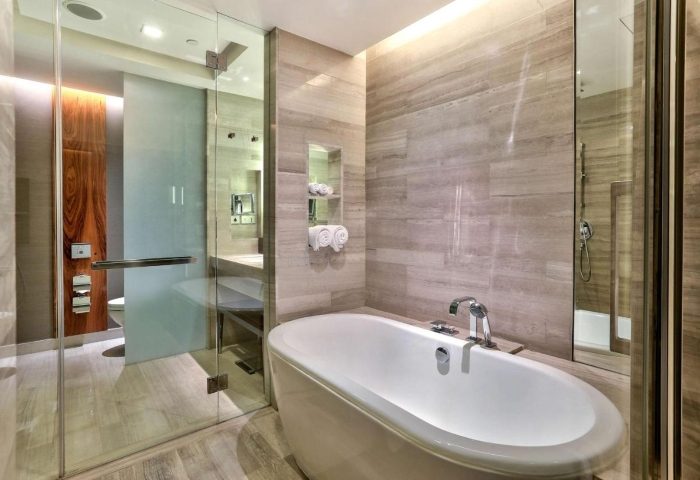 Upscale Hilton Sukhumvit Bangkok hotel bathroom. Bathtub, shower, and modern design. Near gay bars in Bangkok, Thailand. Gay travel.