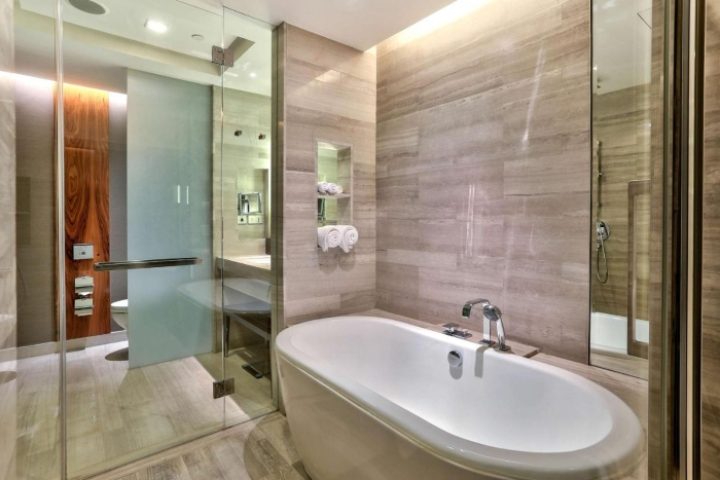 Upscale Hilton Sukhumvit Bangkok hotel bathroom. Bathtub, shower, and modern design. Near gay bars in Bangkok, Thailand. Gay travel.