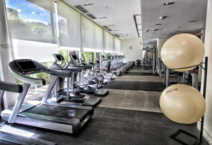 Grand Hyatt Erawan Bangkok gym with treadmills, weights, and exercise balls. One of the top wellness hotels near gay saunas in Bangkok.