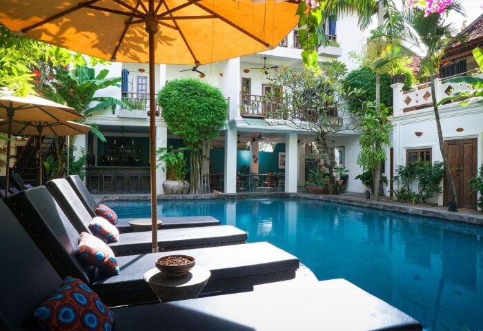 Rambutan Resort Siem Reap swimming pool view. Gay hotel with sun loungers and umbrellas. Top wellness destination for gay men travelers.