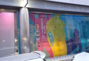 Trombeta Bath Lisbon: Gay sauna exterior. Colorful window art with male figures. A must-visit gay travel destination in Lisbon, Portugal.