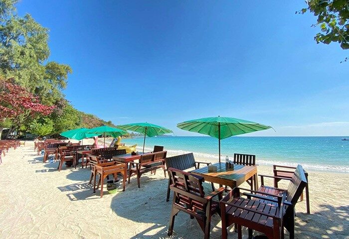 Tubtim Resort Koh Samet: Beachside dining with umbrellas. Best gay beach vibe in Thailand. Tropical travel destination.